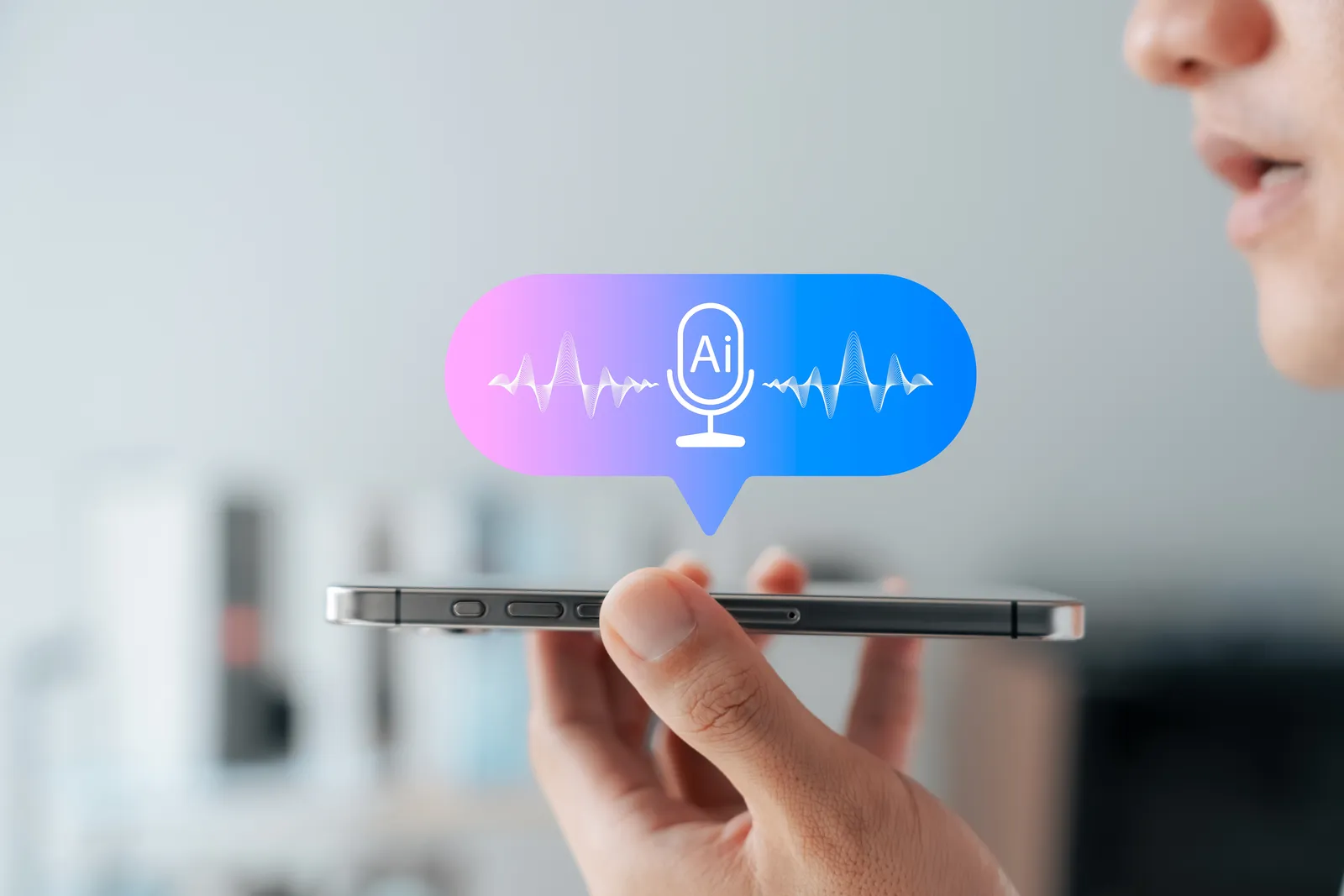 A person speaks into a smartphone with a speech bubble above it showing a microphone icon and two sound waves