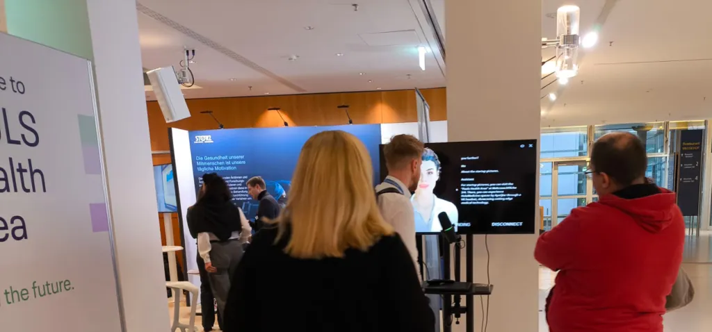 An AI avatar handling repeat visitor questions at a congress